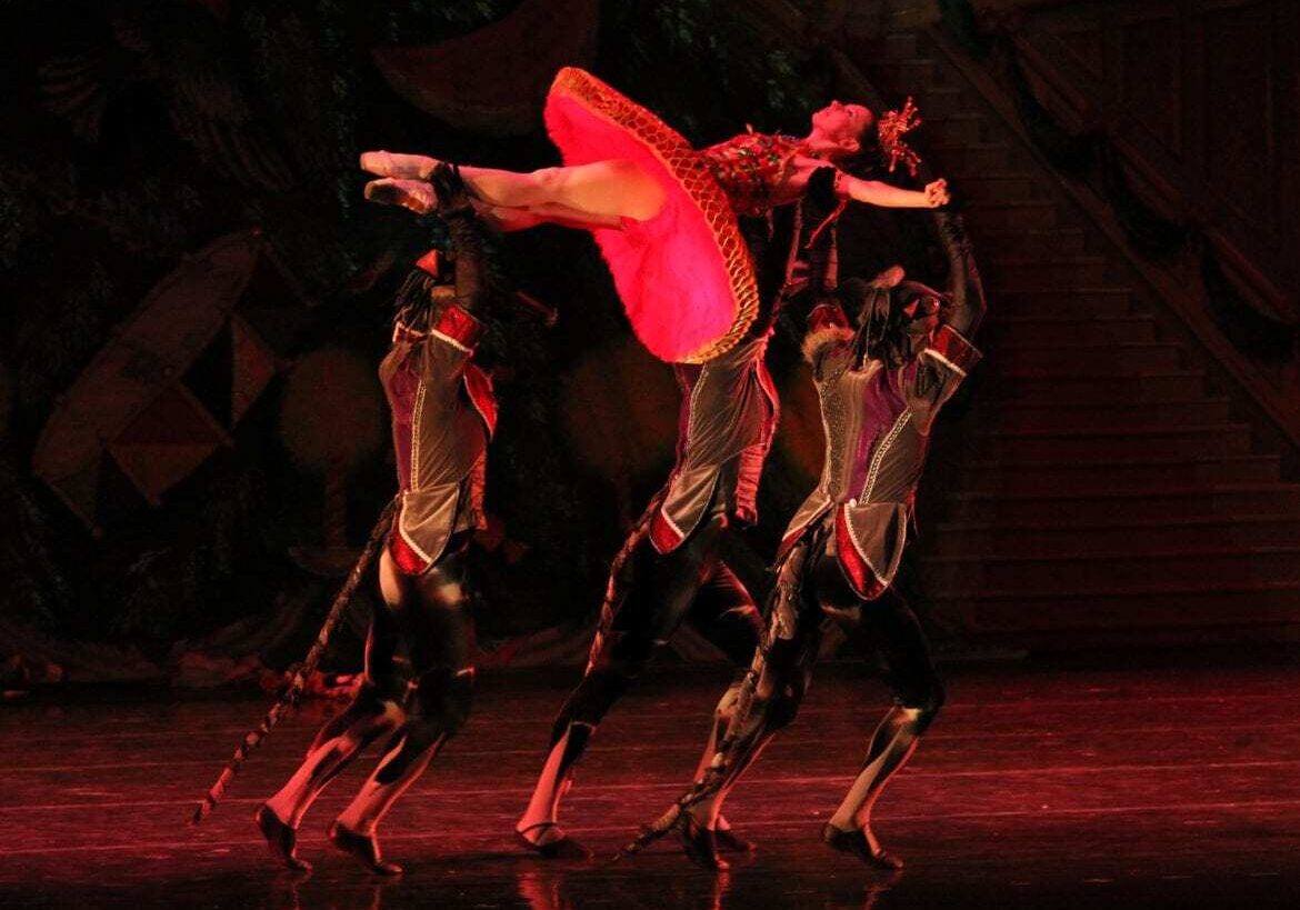 A ballerina being held in the air.