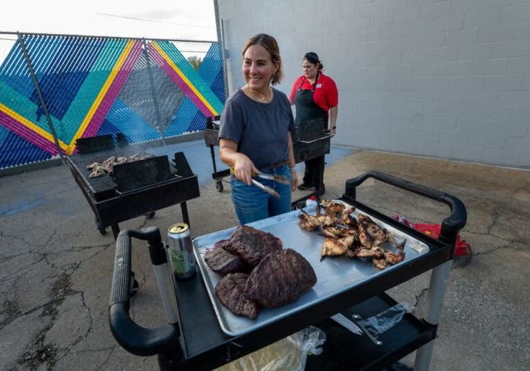 Marissa Gencarelli, of Yoli Tortilleria, grilled steak and Masa Shio Koji wings for an Anti-ICE Supper Club event to raise awareness and benefit Advocates for Immigrant Rights and Reconciliation (AIRR), a regional nonprofit that advocates for immigrant and refugee communities in Kansas and Missouri. The event took place at Yoli Cocina, in Kansas City, Mo. on Tuesday, Oct. 13, 2026. In the background is Laura Basauri, the executive chef for Taco Naco.