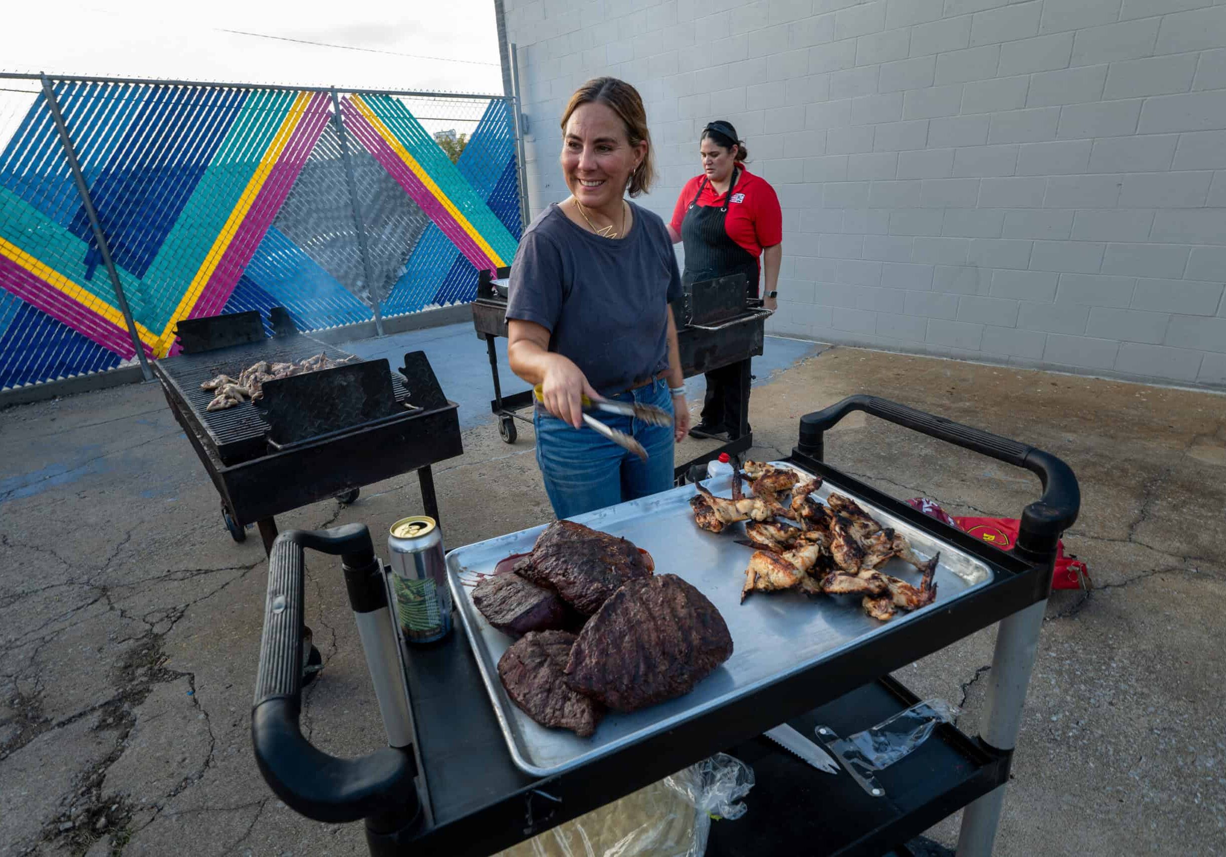 Marissa Gencarelli, of Yoli Tortilleria, grilled steak and Masa Shio Koji wings for an Anti-ICE Supper Club event to raise awareness and benefit Advocates for Immigrant Rights and Reconciliation (AIRR), a regional nonprofit that advocates for immigrant and refugee communities in Kansas and Missouri. The event took place at Yoli Cocina, in Kansas City, Mo. on Tuesday, Oct. 13, 2026. In the background is Laura Basauri, the executive chef for Taco Naco.
