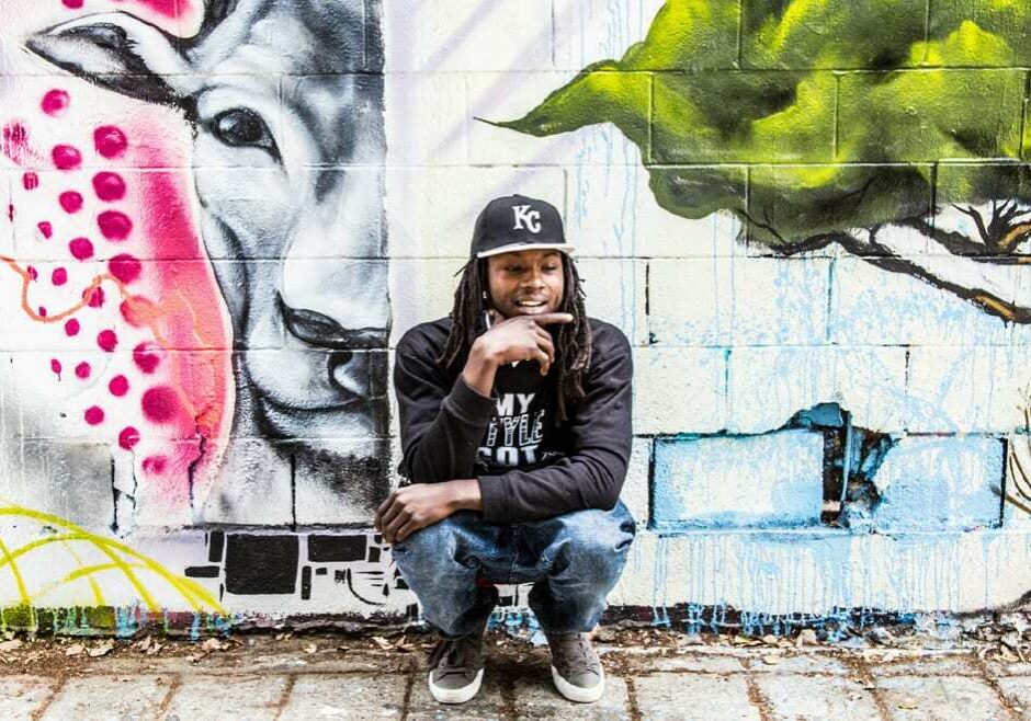 A rapper in front of graffiti