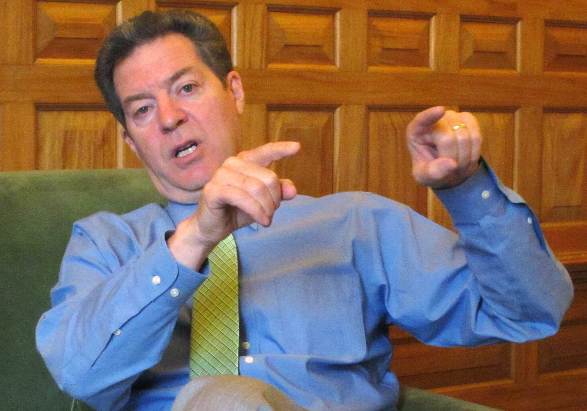 In this April 13, 2015 photo, Kansas Republican Gov. Sam Brownback makes a point during an interview in his office in the Statehouse in Topeka, Kan. Brownback is preparing to sign welfare legislation restricting how poor families can spend cash assistance from the state. The Republican governor scheduled a Thursday, April 16, 2015, morning signing ceremony at the Statehouse. (AP Photo/John Hanna)