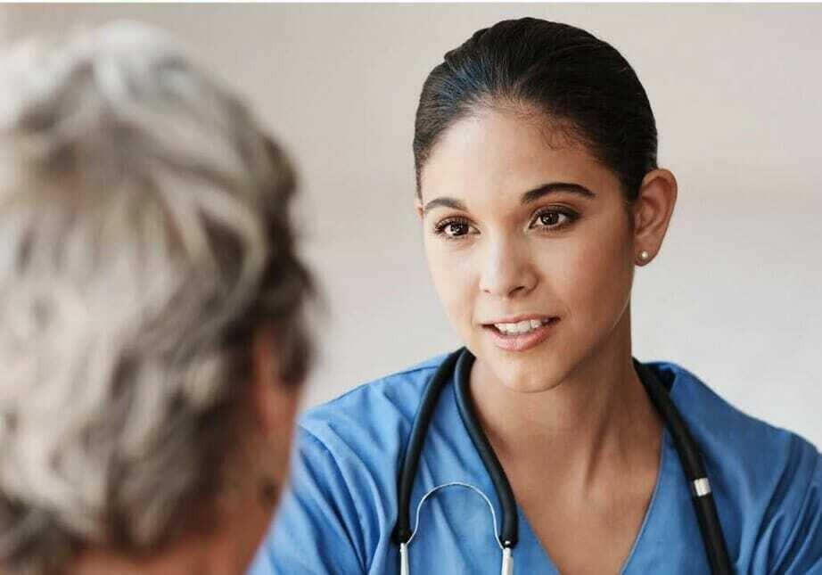 A caregiver meets with a patient.
