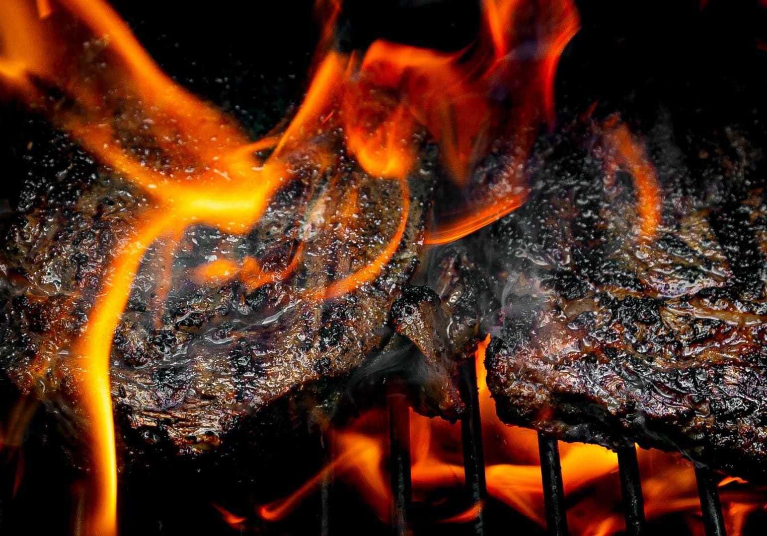 Barbecue engulfed in flames.