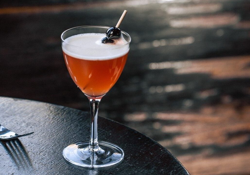 A craft cocktail on a table.