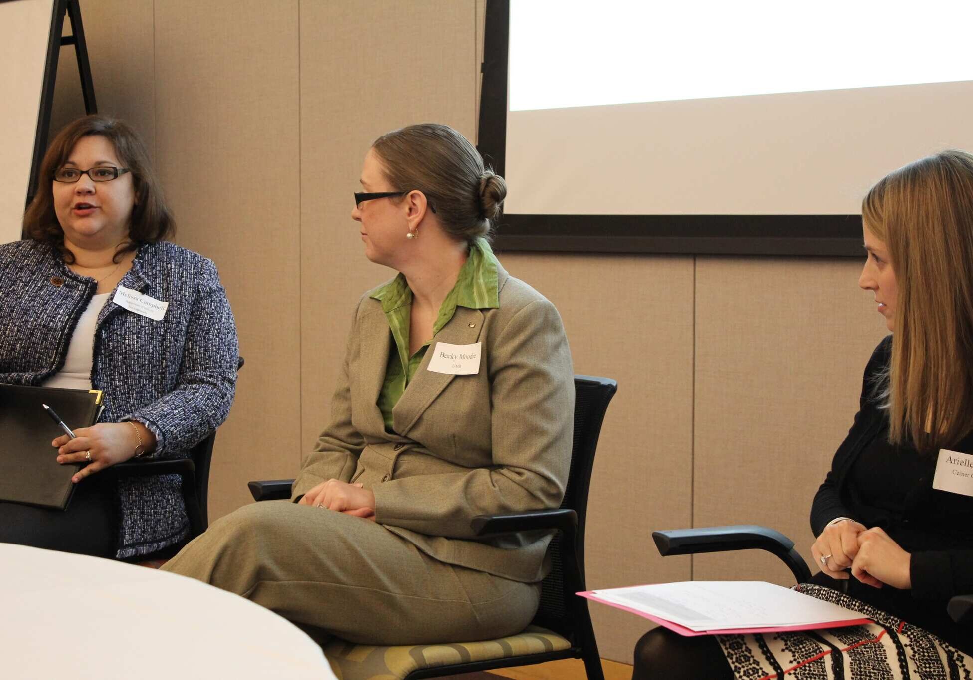 Arielle Bogorad (right) of Cerner Corp., and Becky Moodie of UMB Financial listened Tuesday as Melissa Campbell of American Century Investments discussed her company's participation in the CEO Cancer Gold Standard accreditation program. (Photo by Mike Sherry/The Hale Center for Journalism)