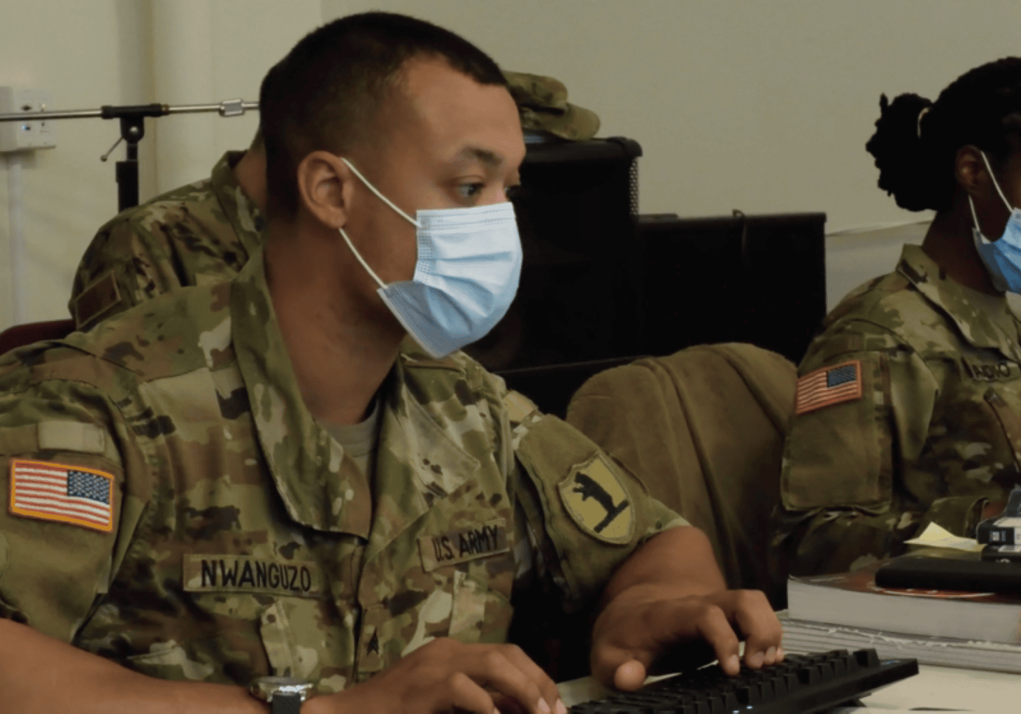 Sgt. Patrick Nwanguzo and Specialist Crystal Baddoo of the Missouri Army National Guard process Covid-19 vaccination information at the Morning Star/LINC vaccination clinic in Kansas City.