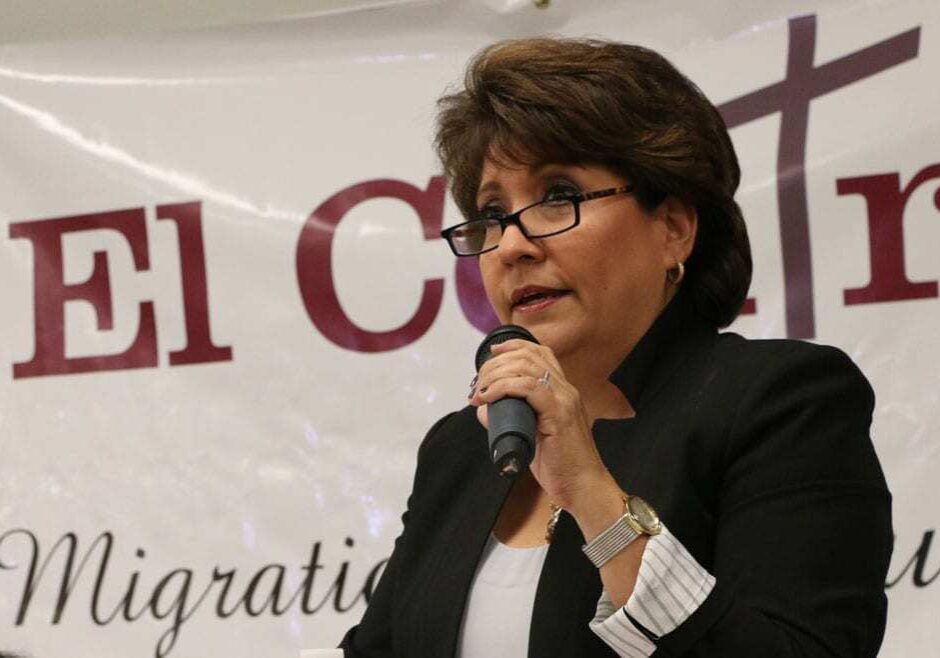 Latina woman speaks at a podium