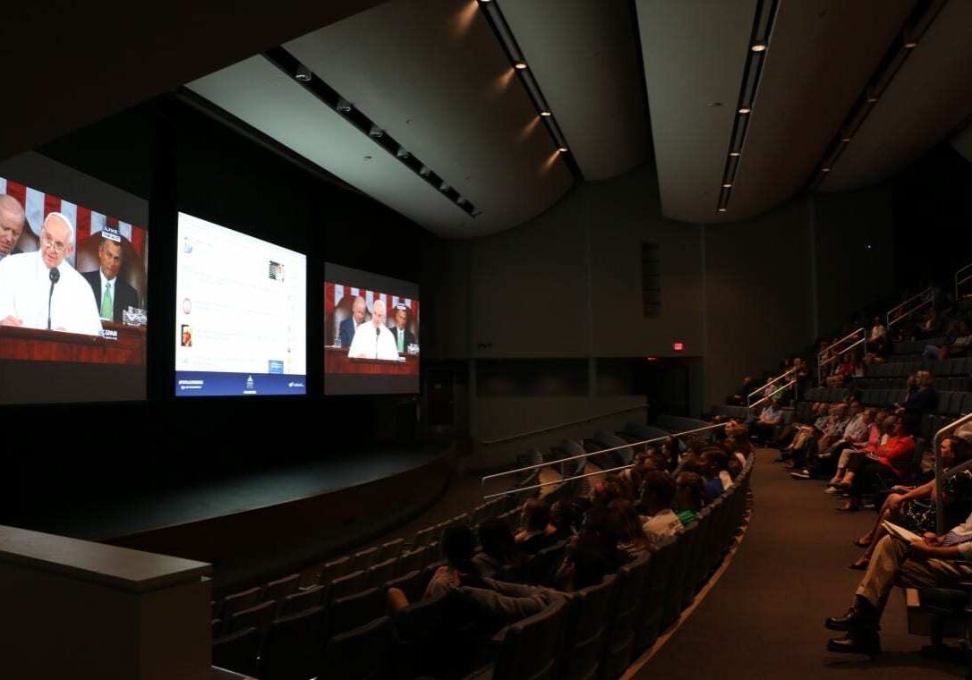 People watch the Pope address Congress at Rockhurst University's auditorium. 