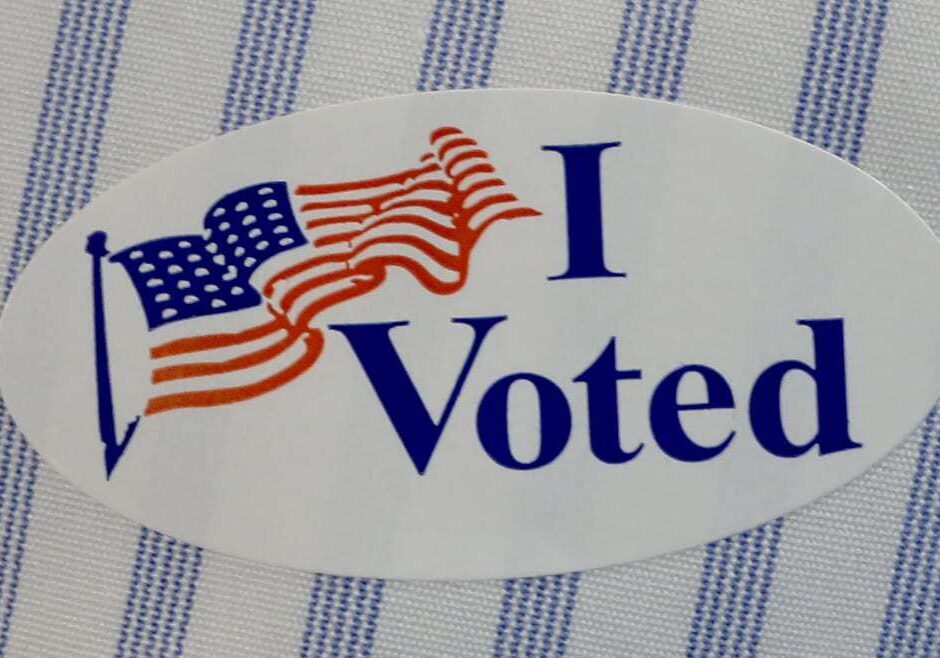 Image of "I Voted" sticker on a striped shirt