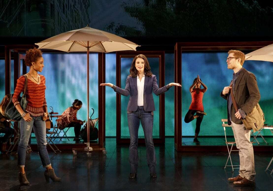 A woman stands on a stage.