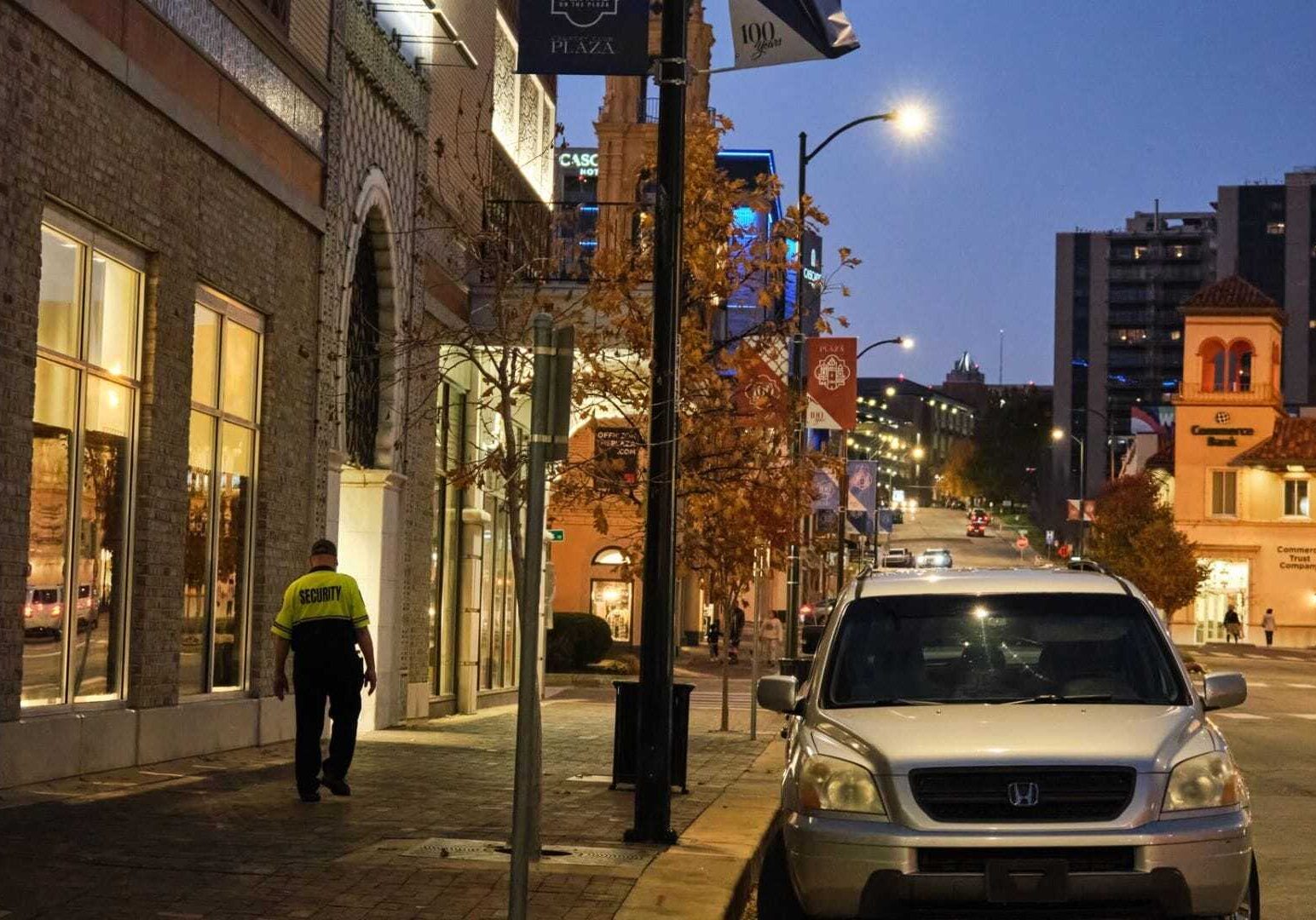 A lone security guard, part of The Country Club Plaza's private crew, can often be seen walking in the area. The neon portion of the guard's uniform alerts shoppers.
