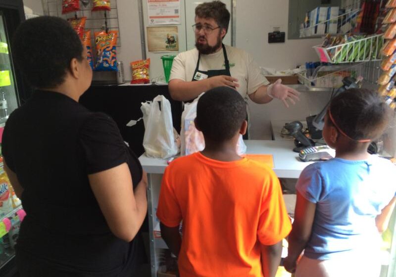 Rolling Grocer employee talking to customers