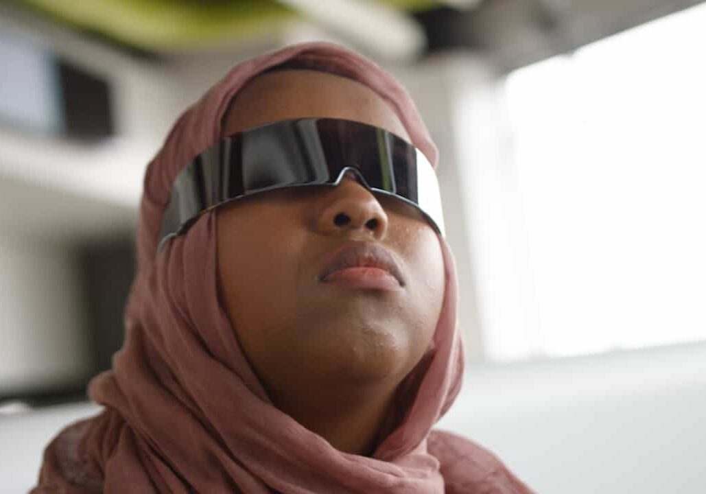 student with reflective glasses looking to the distance