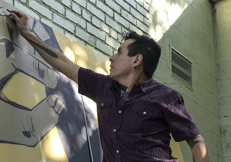 Kansas City Art Institute Illustration instructor Hector Casanova works on a mural panel for Scarritt Elementary. (Photos: Julie Denesha | Special Correspondent to KCPT)
