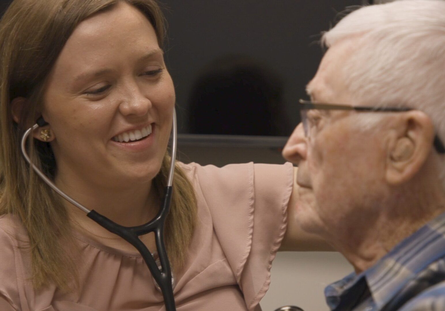 A medical student examines a patient
