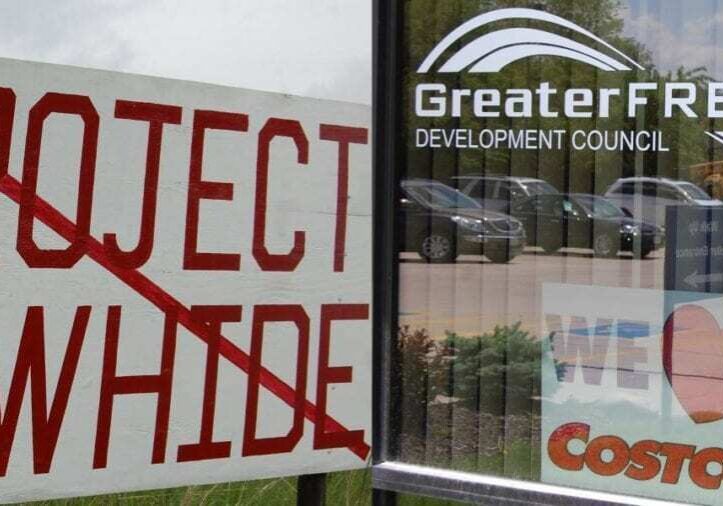 "Project Rawhide" crossed out near a storefront.