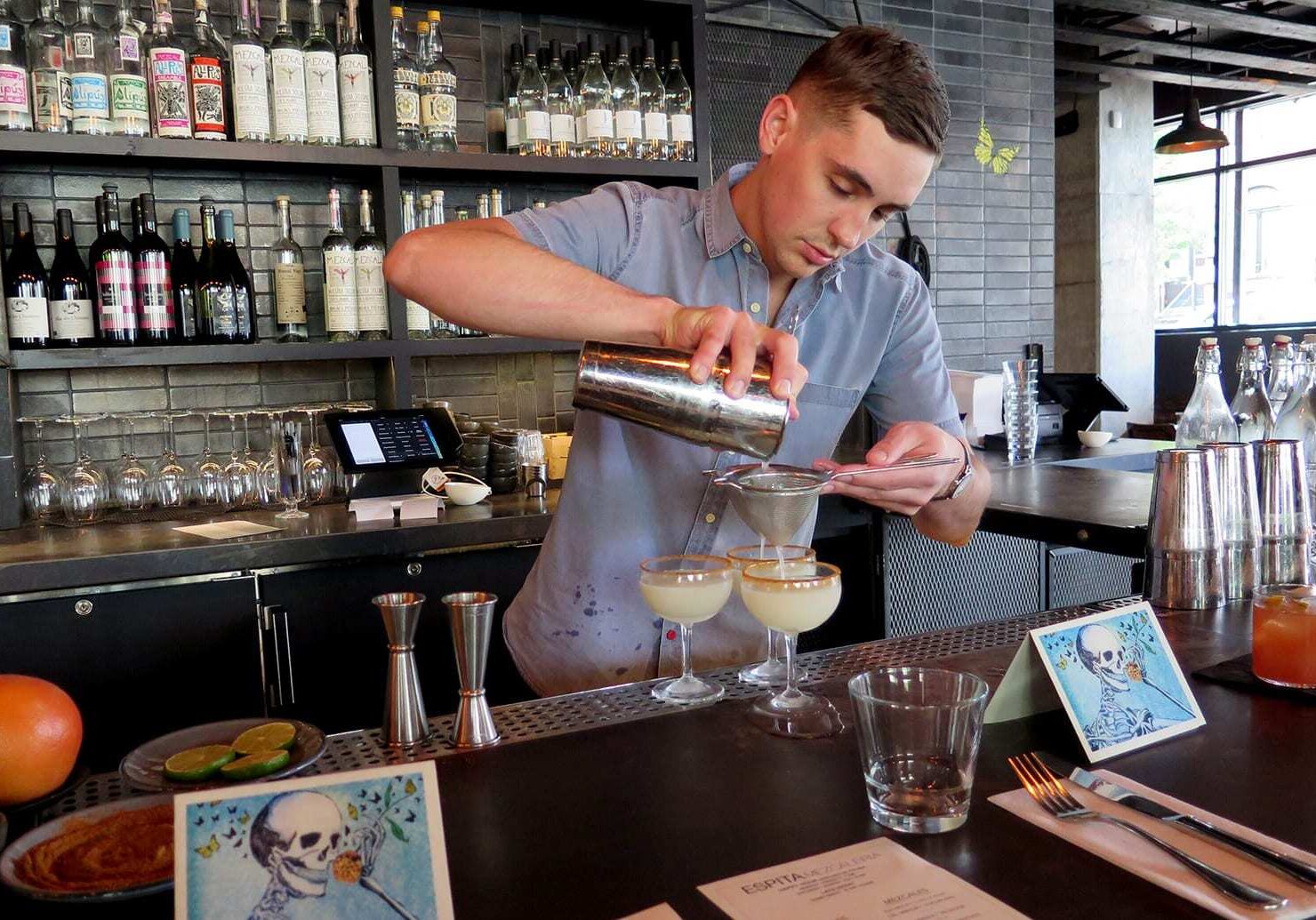 Bartender Robin Miller mixes a round of mezcal margaritas at Espita Mezcaleria in Washington, D.C. As U.S. drinkers embrace mezcal, investors are flocking south to the heart of Mexico's mezcal country, and local incomes are risin