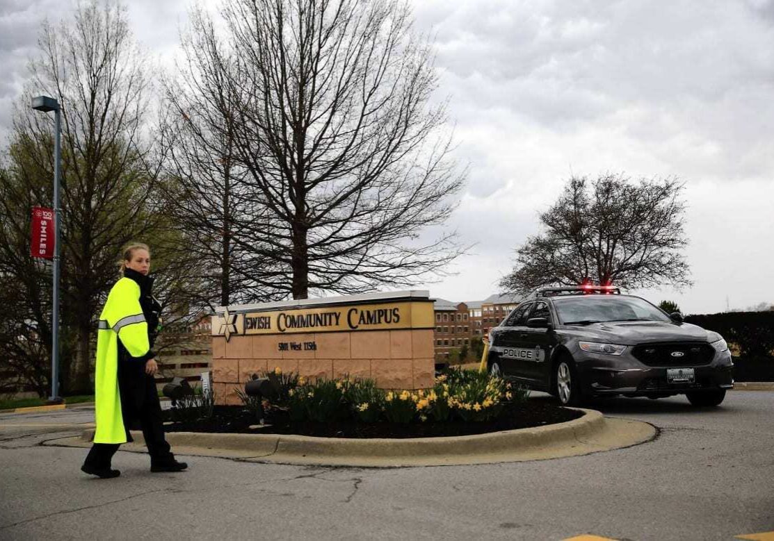 OVERLAND PARK, KS - APRIL 13:  A police woman and police car are seen at the entrance of the Jewish Community Center after three were killed when a gunman opened fire on April 13, 2014 in Overland Park, Kansas. Police arrested and are questioning a suspect.  (Photo by Jamie Squire/Getty Images)