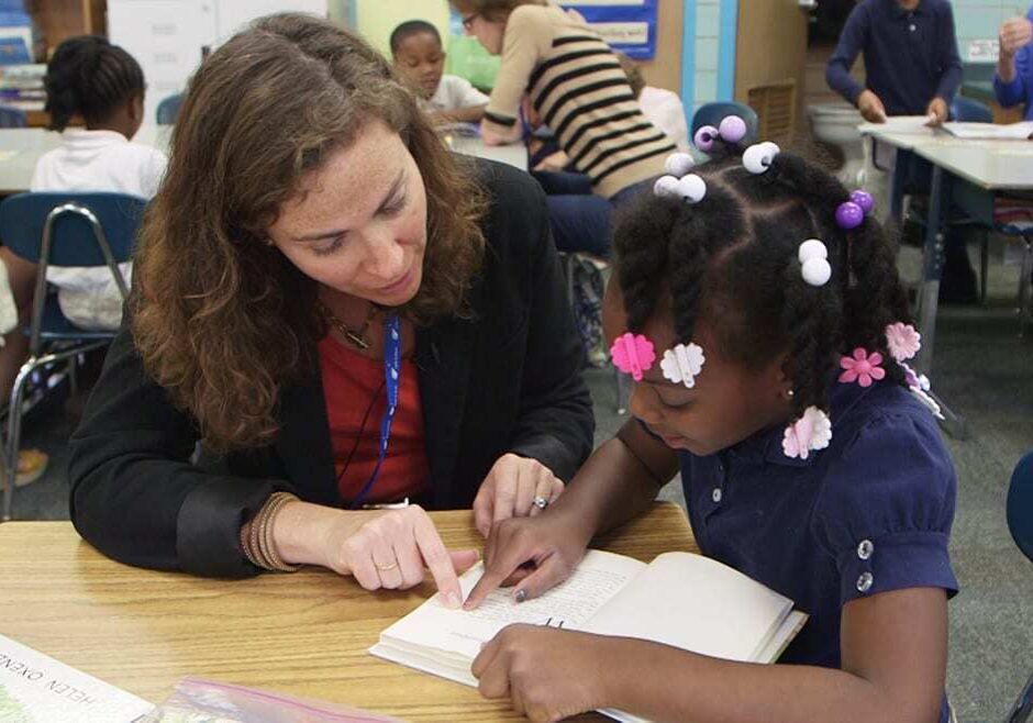 Image of woman reading with little girl.