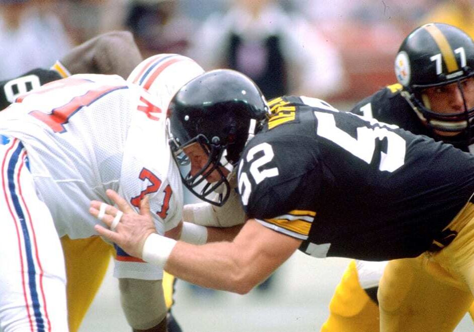Two football players from opposing teams butt heads.