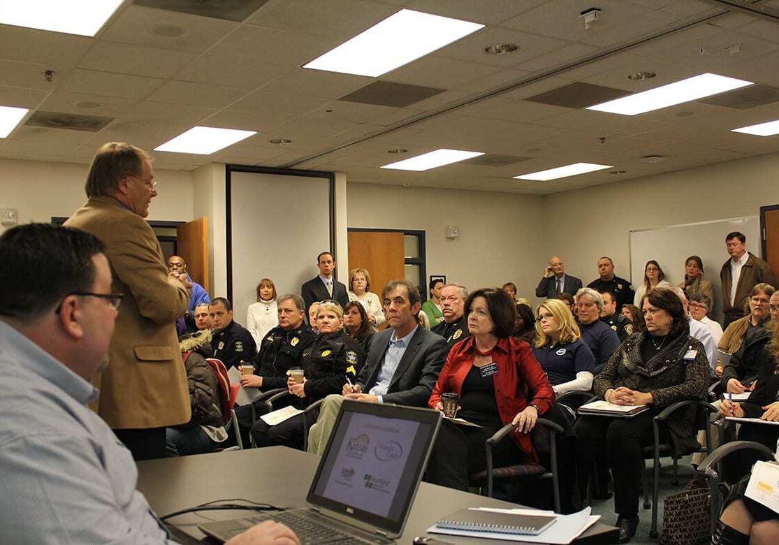 Pete Zevenbergen, CEO of the Wyandot Center in Kansas City, Kan., spoke Friday at a forum designed to update stakeholders on a new plan for the former Rainbow Mental Health Facility near the University of Kansas Medical Center. In the foreground is Tim DeWeese, clinical director of the Johnson County Mental Health Center. (Photo by Mike Sherry/The Hale Center for Journalism)