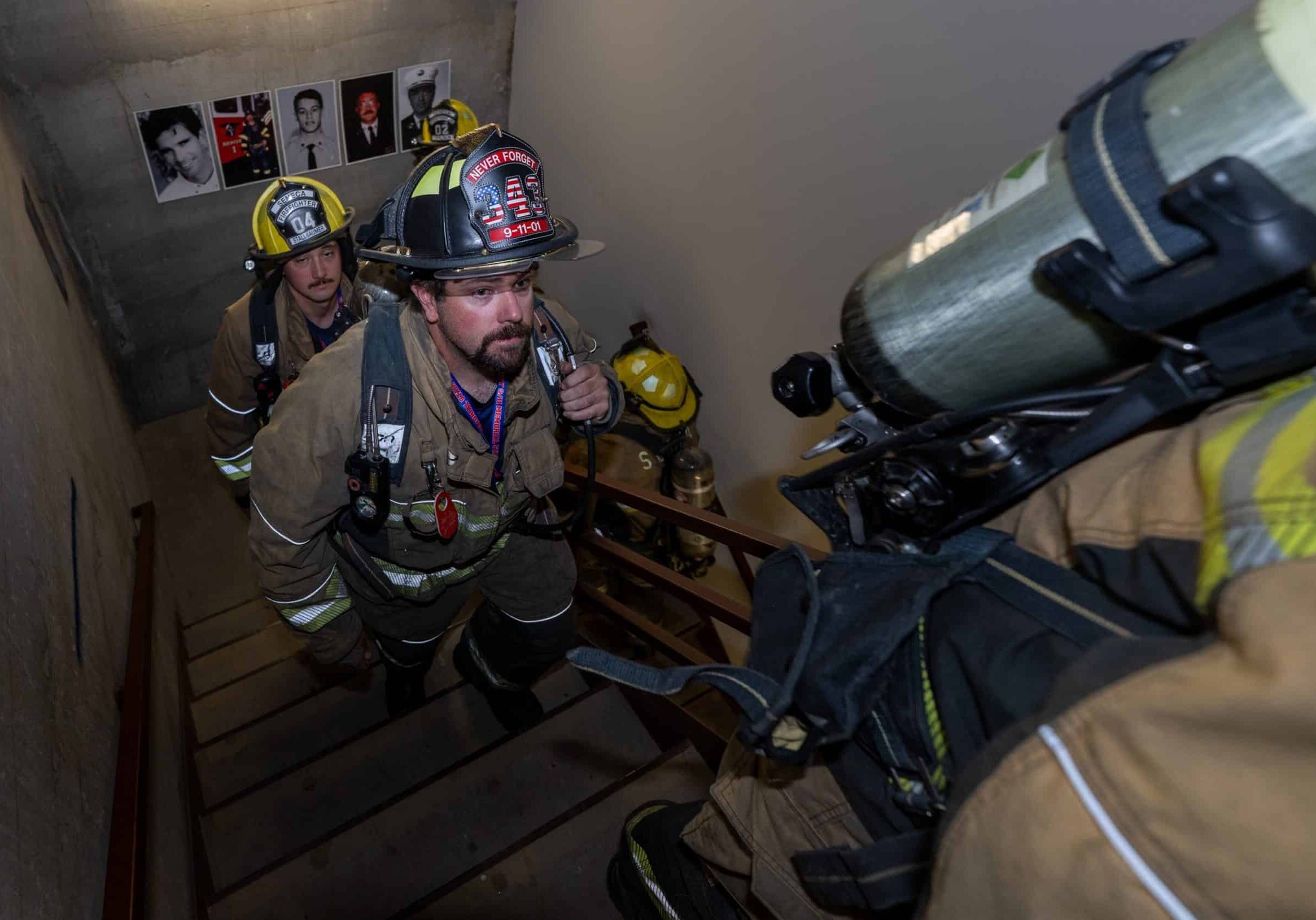 Robert Ohlsen from the Seneca, Kansas Fire Department, climbs another flight of stairs on Sept. 6, 2026, in honor of the 343 firefighters that lost their lives 25 years ago when the Twin Towers collapsed. The participating firefighters climbed 110 stories to represent the height of the Twin Towers. Posted on each landing are photos of firefighters killed in the aftermath of the terrorist attack. (Todd Feeback | Flatland)
