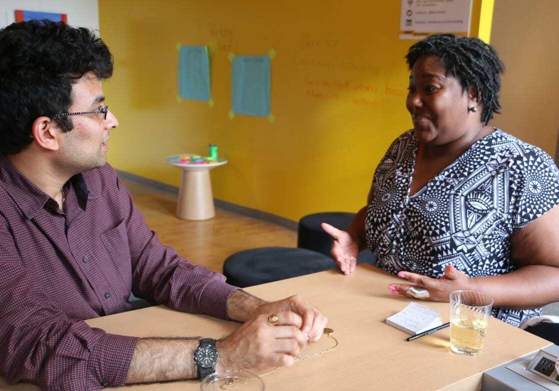 Catina Taylor talks with Aditya Voleti at a meeting