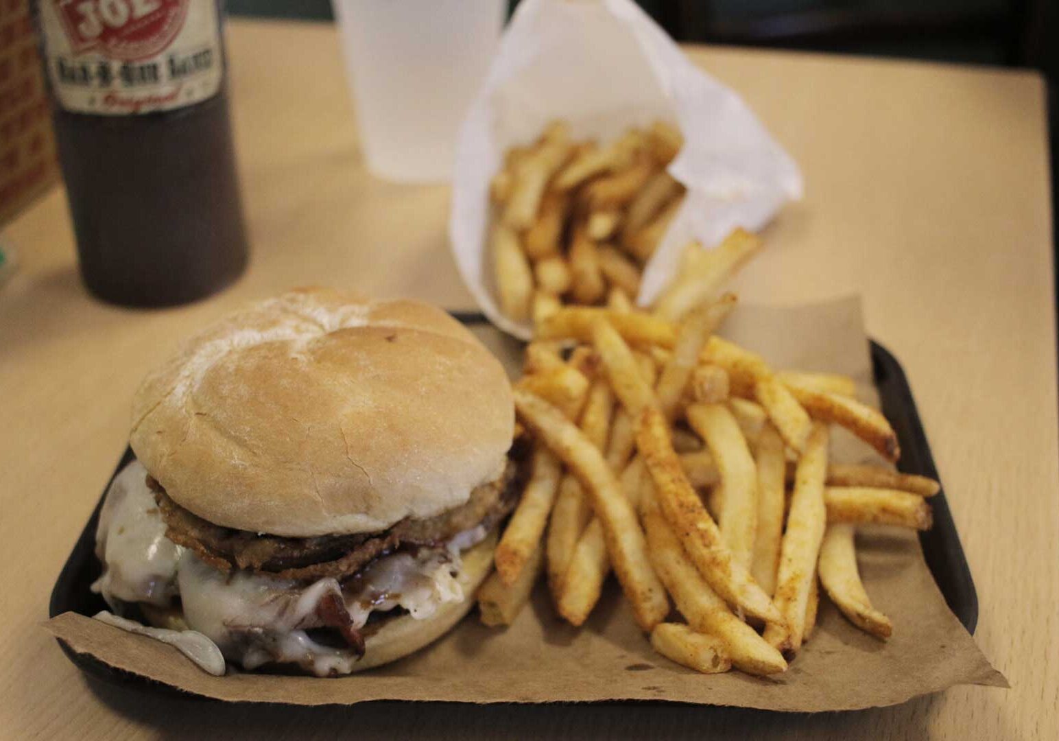 The Z-man combines smoked brisket, onion rings, smoked provolone, and barbecue sauce on a toasted egg bun. (Photos: Cole Blaise | Flatland)